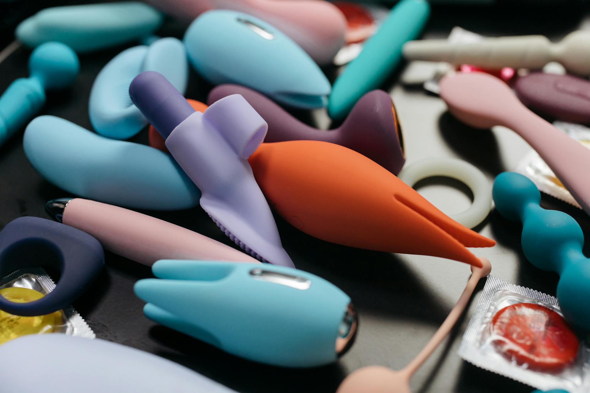 A vibrant display of clitoral vibrators and intimate wellness products arranged in close-up detail.